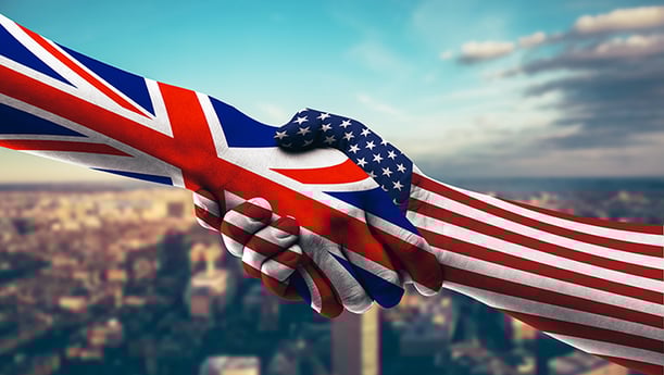 An abstract image of two hands shaking. One in the flag of the USA, and one in the flag of the UK