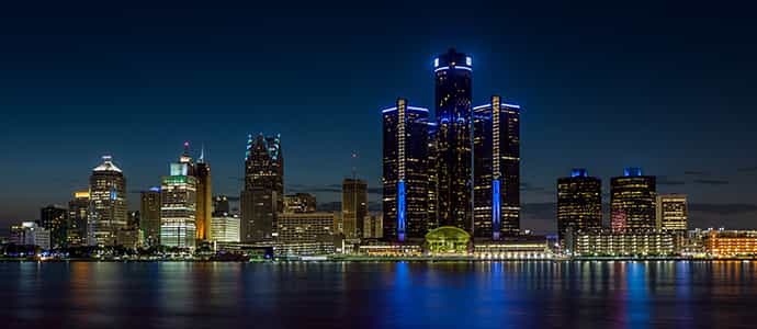 photo of an illuminated waterfront skyline at night