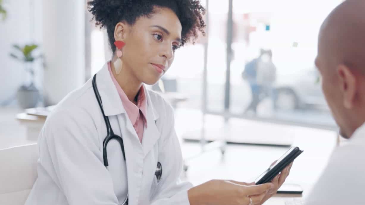 A medical professional speaking with a patient