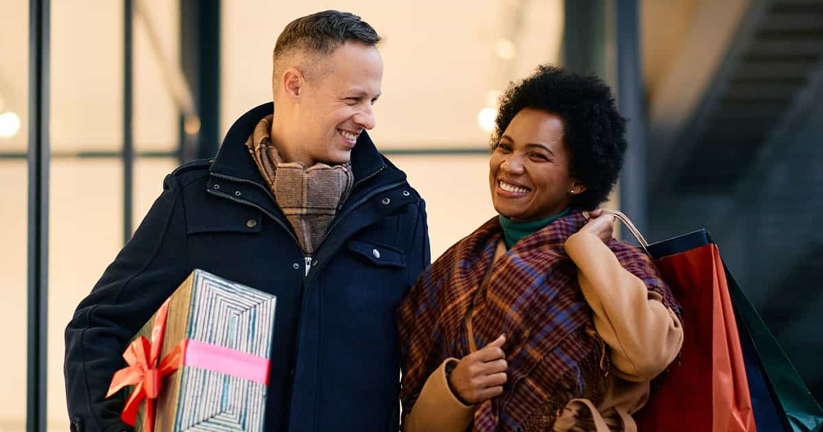 A happy couple shopping during the holiday season.