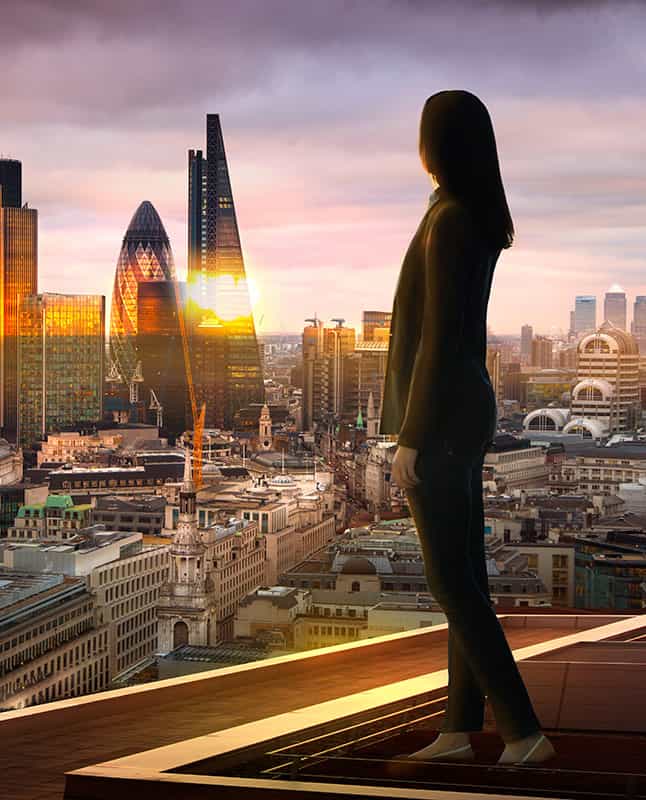 An image of a woman stood in a window looking over the London skyline