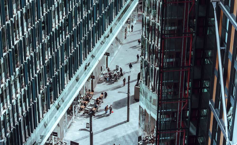 An abstract image of two office buildings with a walkway in between, taken from above