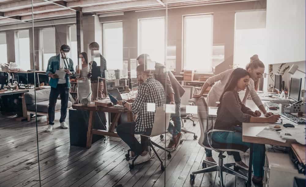 A group of young people working in a busy modern office