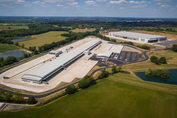 An aerial image of two large warehouse units surrounded by greenfield land