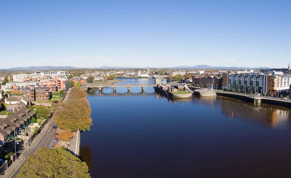 An aerial image of a downtown city centre with a river passing through the centre of the image