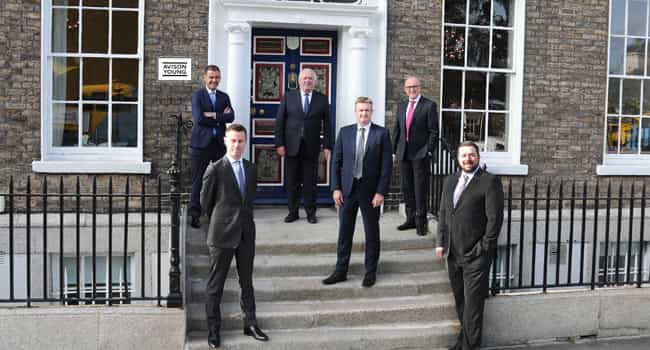 The Avison Young team standing outside the entrance to the office in Dublin