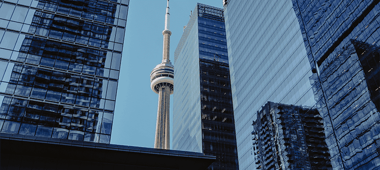 CN tower in the background behind office building skyscrapers reflecting one another