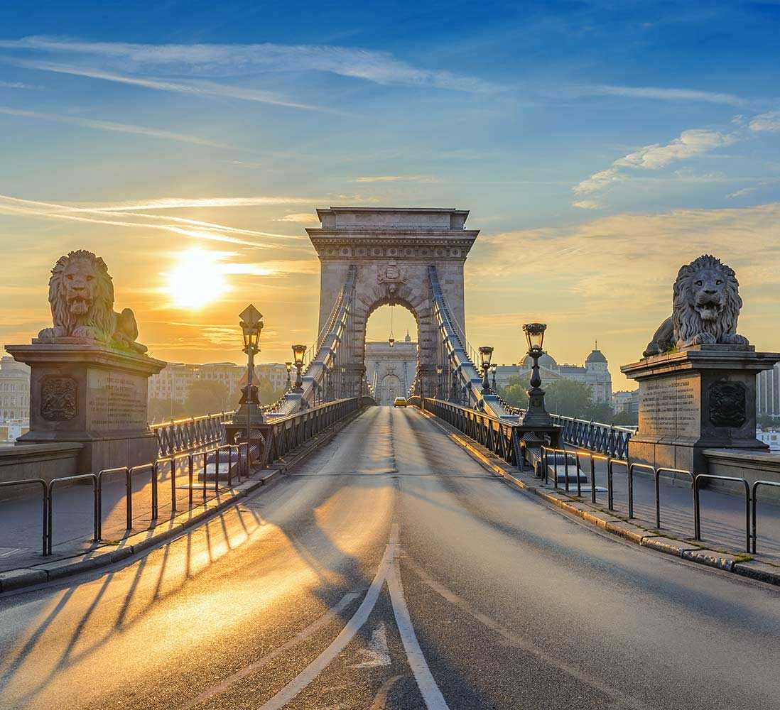 An image of a grand bridge crossing a river in a city centre