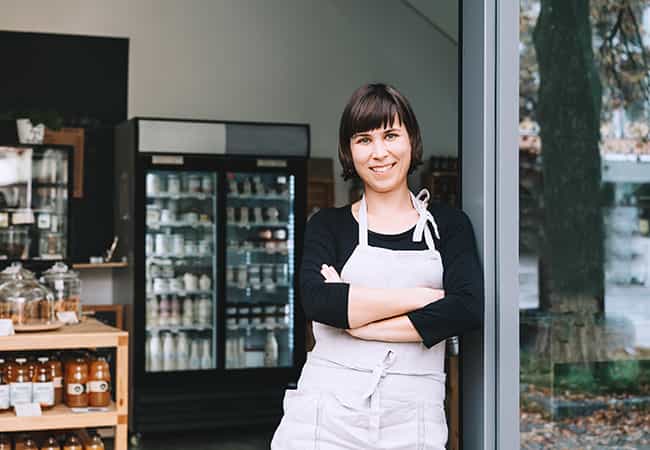 retail property owner stands in the doorway of their shop in Edmonton