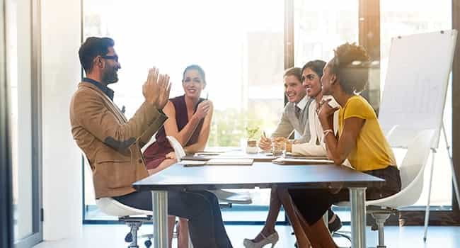 A group of people sitting around a table talking