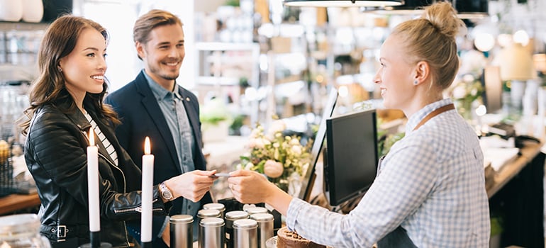 Customers inside a store making a payment by card